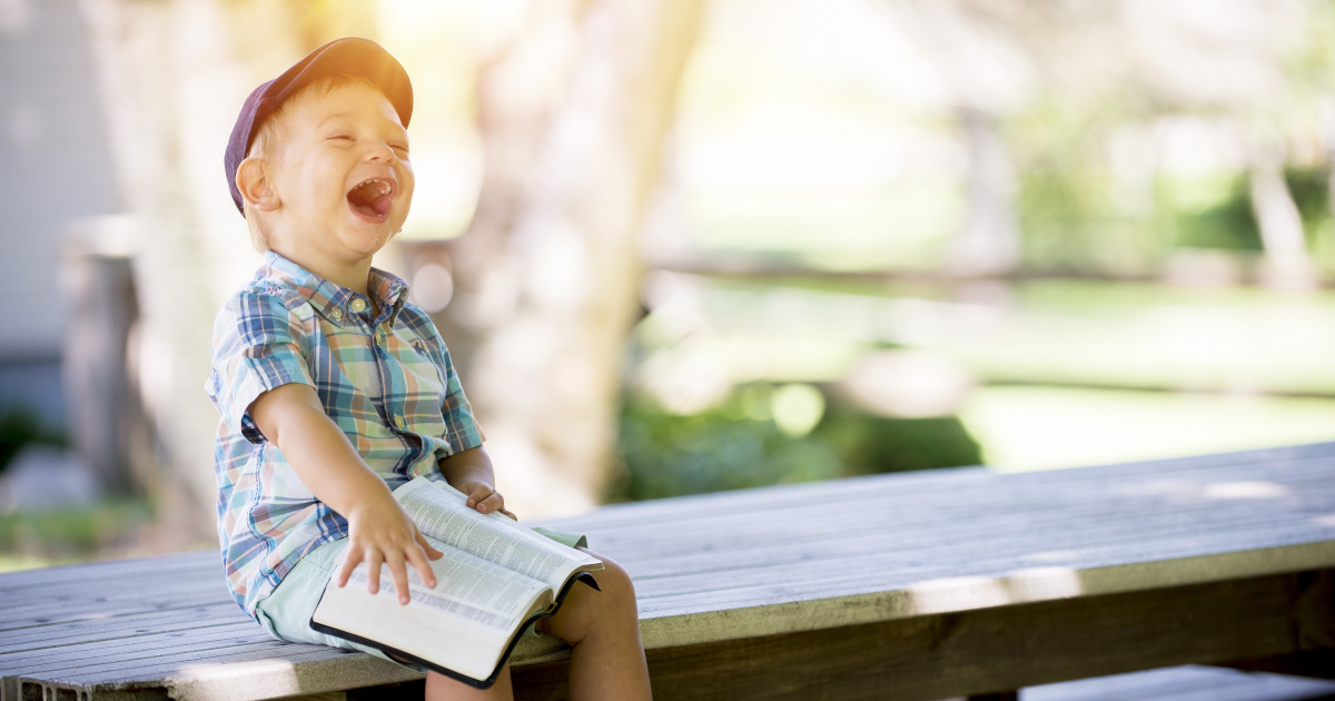 A happy boy with a Bible