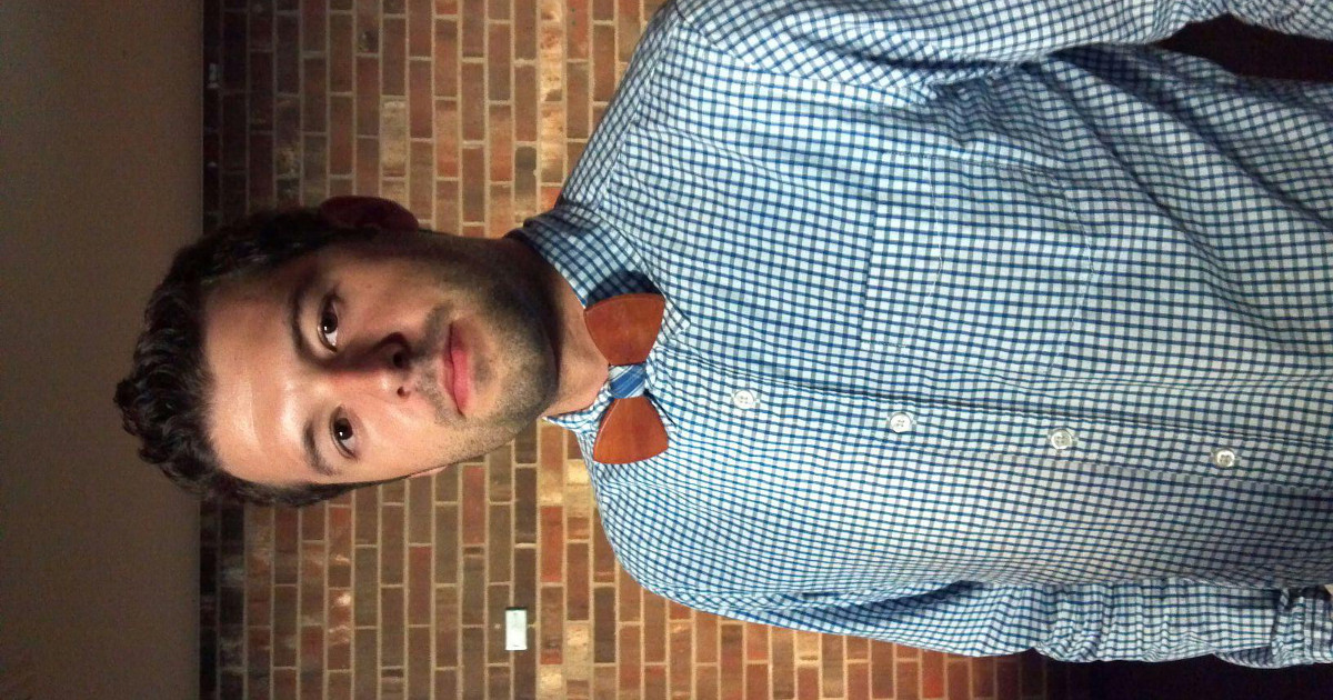 A sideways image of Brandon Caples wearing a wooden bowtie (circa 2013)